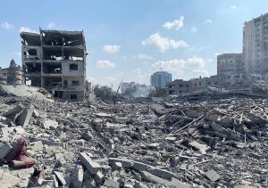 Palestinians inspect the damage following an Israeli airstrike on the El-Remal aera in Gaza City on October 9, 2023. Israel continued to battle Hamas fighters on October 10 and massed tens of thousands of troops and heavy armour around the Gaza Strip after vowing a massive blow over the Palestinian militants' surprise attack. Photo by Naaman Omar apaimages
